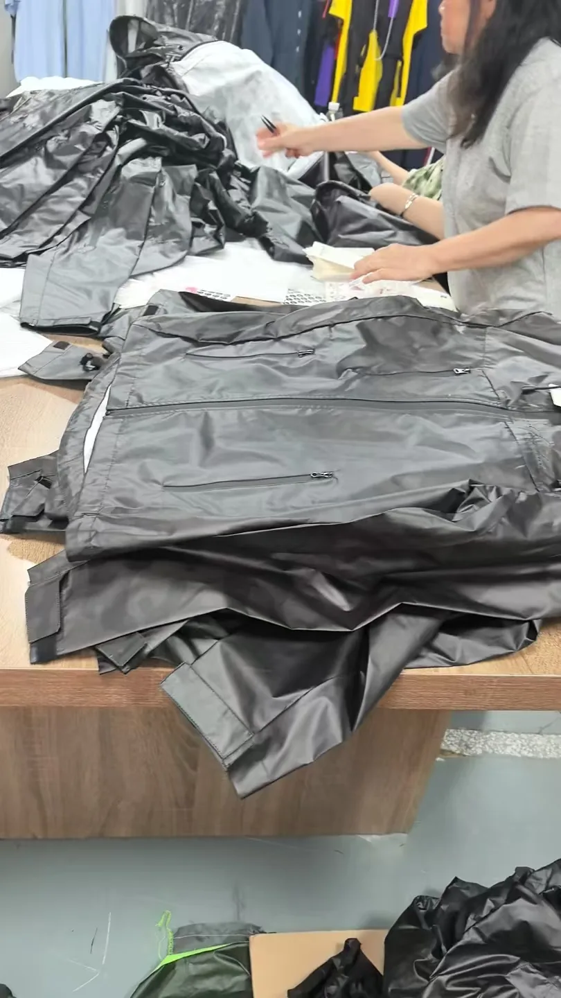 Production table where windbreakers are being sorted and folded