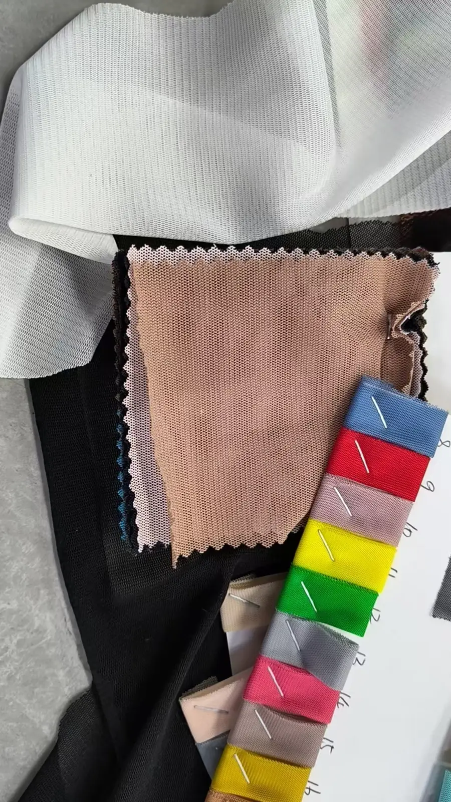 Color fabric swatches and trims laid out for comparison